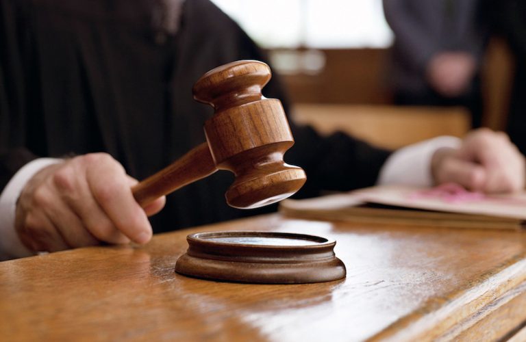 tahkim Judge holding gavel in courtroom